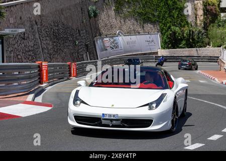 Monte Carlo, Monaco - View on a white Ferrari 458 Italia driving on the road in the Fairmont Hairpin. Stock Photo