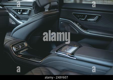Beautiful dark grey colored interior of a luxurious car from natural leather. Stock Photo