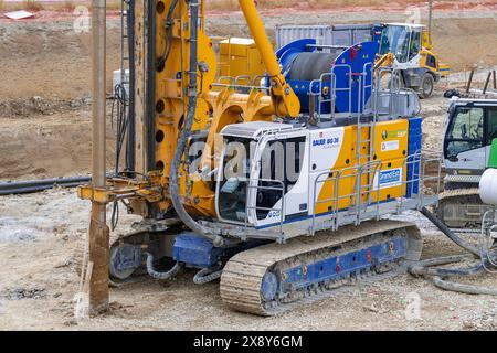 Nancy, France - Yellow and blue drilling rig Bauer BG 36 for special foundations on a construction site. Stock Photo