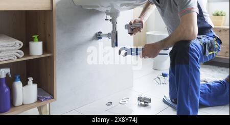 Plumber replacing sink pipes at home, professional service concept Stock Photo