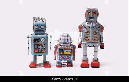 Funny cute tin toy robots standing together on white background Stock Photo