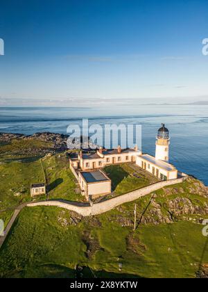 Aerial view of Neist Point Lighthouse situated on a dramatic rocky ...