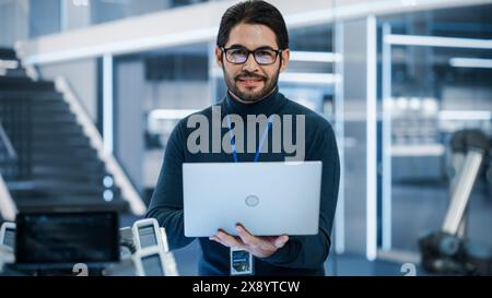 Portrait of a Professional Hispanic Man Using Laptop at Work in Research and Development Agency. Young Multiethnic Male Engineer, Developer or Scientist Working in Development Technology Office. Stock Photo