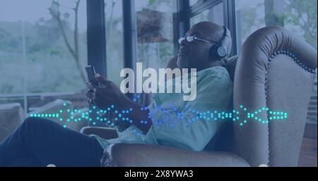 Image of music data processing over african american man with headphones Stock Photo