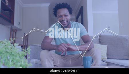 Image of data processing over african american man smiling and talking looking at the camera Stock Photo