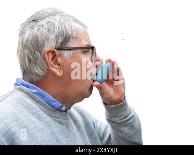 Senior man using asthma pump Stock Photo