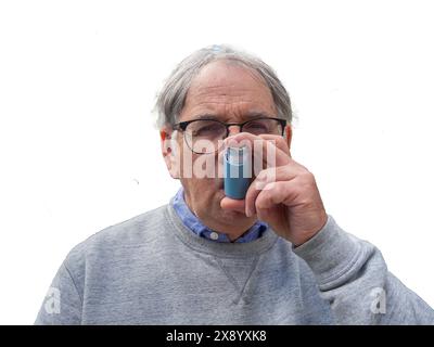 Senior Man Using Asthma Inhaler For Allergies Stock Photo