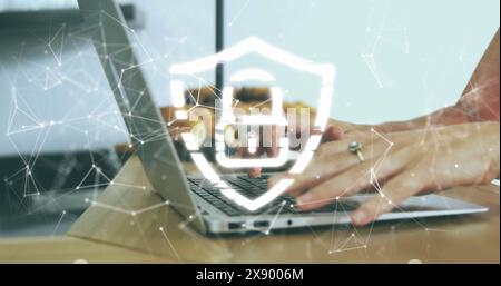 Image of security padlock icon against mid section of a woman using a laptop at office Stock Photo
