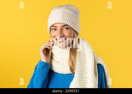 Woman Wearing White Hat and Scarf Isolated on Yellow Stock Photo