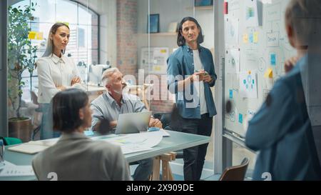Multiethnic Business Team Discussing Strategy in a Meeting Room at the Office. Latin Male Designer Brainstorming with Heads of Departments and Deciding on a Marketing campaign for New Product Launch Stock Photo