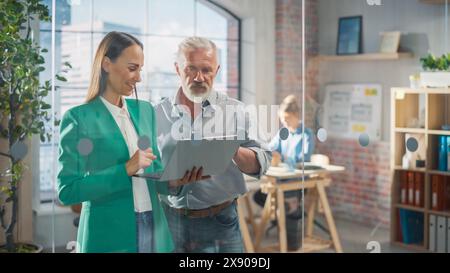 CEO and Chief Executive Talking About Company Business Growth, Consult Data Analysis and Use Laptop Computer. Two Professionals Discussing Revenue Increase, Market Disruption, Planning Strategy Stock Photo