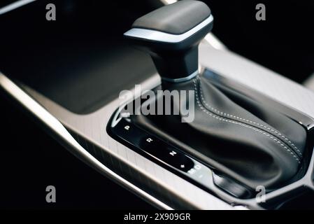 Automatic transmission gearshift stick, Closeup a manual shift of modern car gear shifter. Close up of the automatic gearbox lever, black interior car Stock Photo