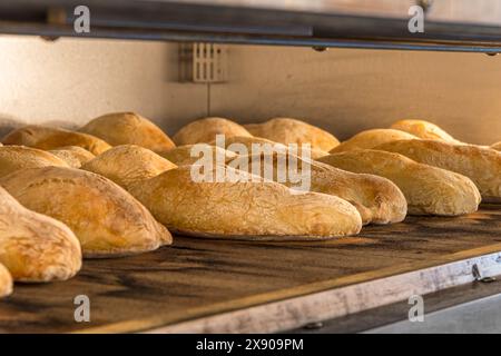 Many loaves of bread baking in oven Stock Photo