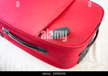 car key on a red suitcase car travel concept Stock Photo