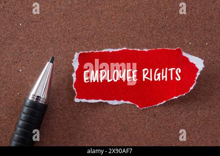 Employee rights words written on ripped red paper with brown background. Conceptual employee rights symbol. Copy space. Stock Photo