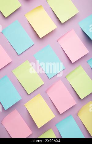 Colorful sticky notes on purple background. Top view Stock Photo