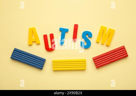 Autism. Autism spectrum disorder. Autism word made with playdough on beige background. Top view Stock Photo