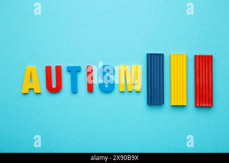 Autism. Autism spectrum disorder. Autism word made with playdough on blue background. Top view Stock Photo