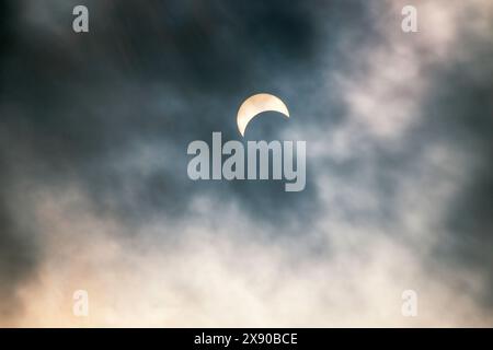 early stage of total Solar Eclipse seen through the clouds  Hamilton, Ontario, Canada, April 8th, 2024 Stock Photo