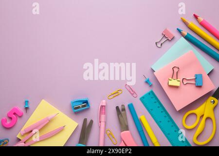 Different stationery on purple background, flat lay with space for text. Stock Photo