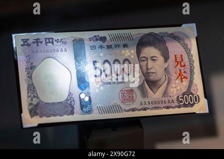 Tokyo, Japan. 27th May, 2024. New Japanese 5000 Yen banknote on display inside the Currency Museum of the Bank of Japan's Institute for Monetary and Economic Studies. The new banknotes will start circulate from July 3, 2024. It is the first re-design since 20 years. The woman on the banknote is Tsuda Umeko, a pioneer in higher education for women. She founded one of the first private women's colleges in Japan, Joshi Eigaku Juku (now Tsuda University). (Photo by Stanislav Kogiku/SOPA Images/Sipa USA) Credit: Sipa USA/Alamy Live News Stock Photo