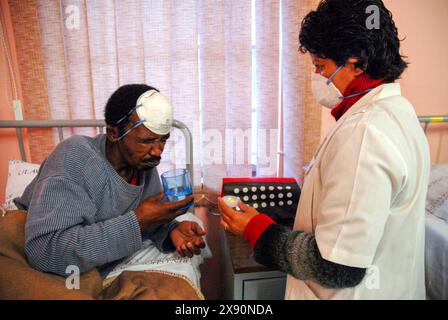 24 July 2007 - South Africa Cape Town; Brooklyn Chest Hospital TB Tuberculosis XDR doctors treat patients in a special isolation ward for drug resistant TB. They are on a special programme to test new medications developed to treat the XDR version of the disease. The patients are hospitalised in a ward with special ventilation, TV, radio and high ratio of staff/patient care during the programme sputum contagious masks doctor nurse pills medication health injection    Photo Credit: Eric Miller / african.pictures Stock Photo