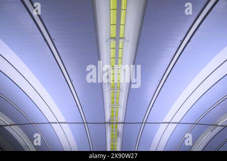 Light fixtures going through the ceiling in curved lines. Stock Photo