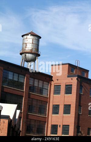 Virginia, U.S.A. Repurposed industrial building with water tank on the roof at Charlottesville Woolen Mills. Stock Photo