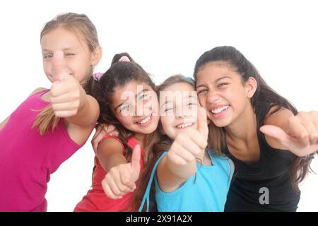 group of cheerful teenage girls showing thumbs up on white background Stock Photo