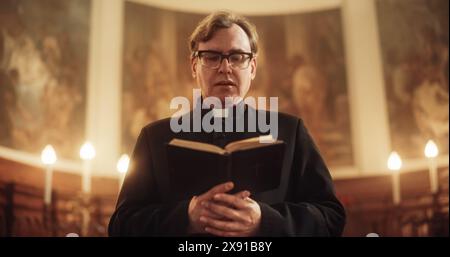 In Christian Church: The Minister Leads The Congregation In Prayer and Reads From The Holy Book, The Bible, Gospel of Jesus. Portrait of Priest Providing Guidance, Belief, Hope, Solace to People Stock Photo