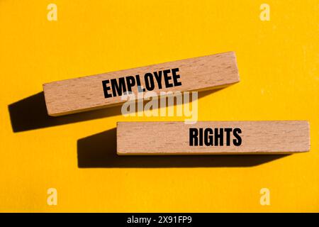 Employee rights words written on wooden blocks with yellow background. Conceptual employee rights symbol. Copy space. Stock Photo