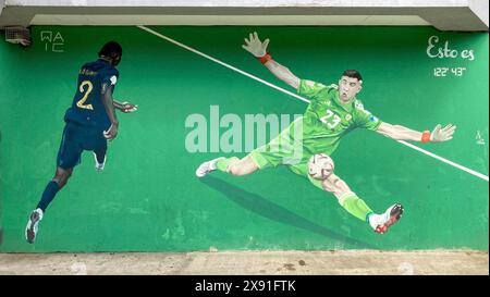 Street art mural shows the Argentinian national goalkeeper Emiliano Martinez in a decisive scene of the final match of the 2022 World Cup, in Buenos Stock Photo