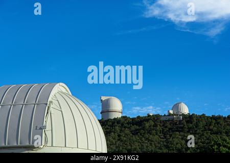 McDonald telescope domes on Mount Locke under blue sky in Davis mountains outside Fort Davis Texas - April 2024 Stock Photo