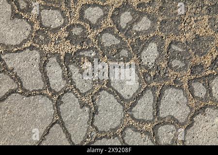 Textured backdrop. Web of cracks. Mosaic texture, background of an old, cracked road. An old asphalt surface, background. Detailed asphalt texture Stock Photo