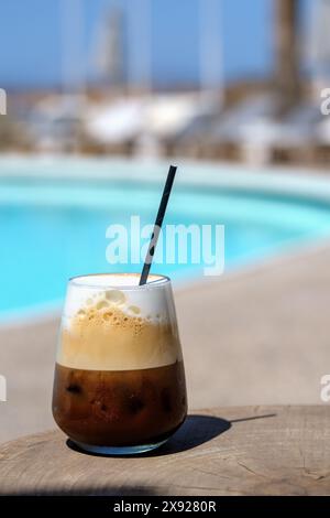 Closeup view of an iced greek  coffee, also known as freddo cappuccino with a straw in Ios Greece Stock Photo