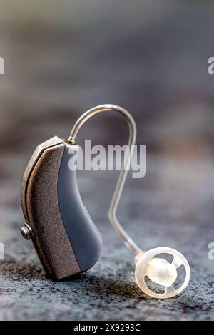 Earpiece in macro on gray background. Hearing impairment-aural auricle 016561 034 Stock Photo