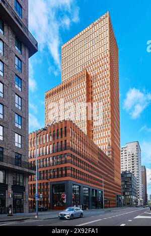 Netherlands, Amsterdam - April 10, 2024: Symphony Buildings at Gustav Mahlerplein. Two orange color skyscrapers in the Zuidas business district Stock Photo