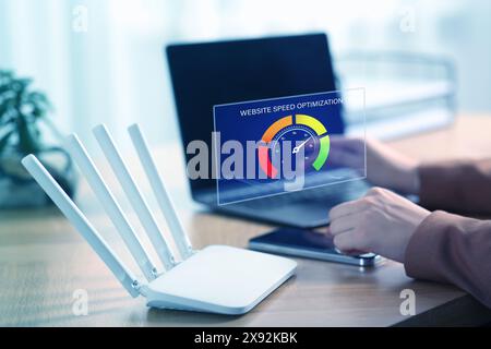 Website speed optimization. Man using laptop at table, closeup. Virtual screen over device Stock Photo