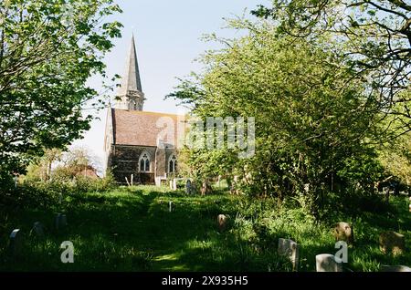 The churchyard of St Mary and St Peter at the village of Pett, near Hastings, East Sussex, UK Stock Photo