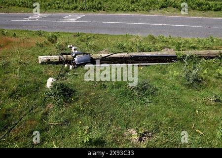 A roadside casualty of a driving accident with a heavy vehicle having hit a telegraph pole and snapped it knocking the top part over. Stock Photo