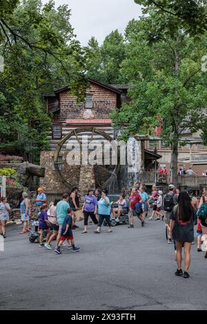 Park guests walking past the Dollywood Grist Mill at the Dollywood amusement park in Pigeon Forge, TN Stock Photo