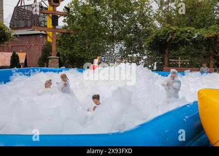 Park guests playing in the bubble foam pit at the Dollywood amusement ...