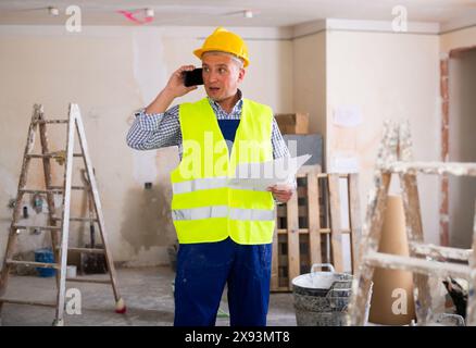 Construction worker having telephone conversation Stock Photo