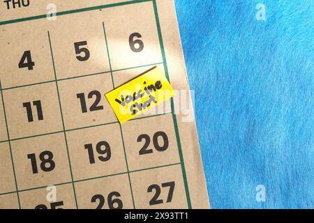 Vaccine shot schedule concept. Written reminder note on calendar. Stock Photo