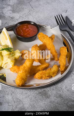 Deep fried shrimp tempura with potato salad on a metal plate Stock Photo