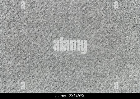 Close-up view of sandpaper texture in sunlight capturing its abrasive surface. Stock Photo