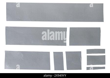 Assorted strips of woven carbon tape adhesive on white background. Multiple pieces of reinforced construction tape in various sizes isolated. Stock Photo