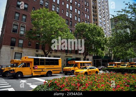 Yellow Taxi Cabs and School Buses on Park Avenue in the Upper East Side of Manhattan, New York City Stock Photo