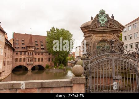 NUREMBERG, GERMANY - MAY 17, 2024: View of Heilig-Geist-Spital from Museumsbrücke in Nuremberg, Germany Stock Photo