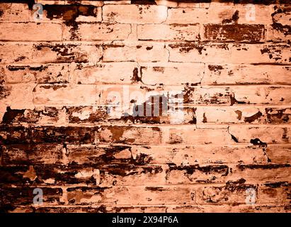 Brick wall background. Peach fuzz is color of year 2024. Stock Photo
